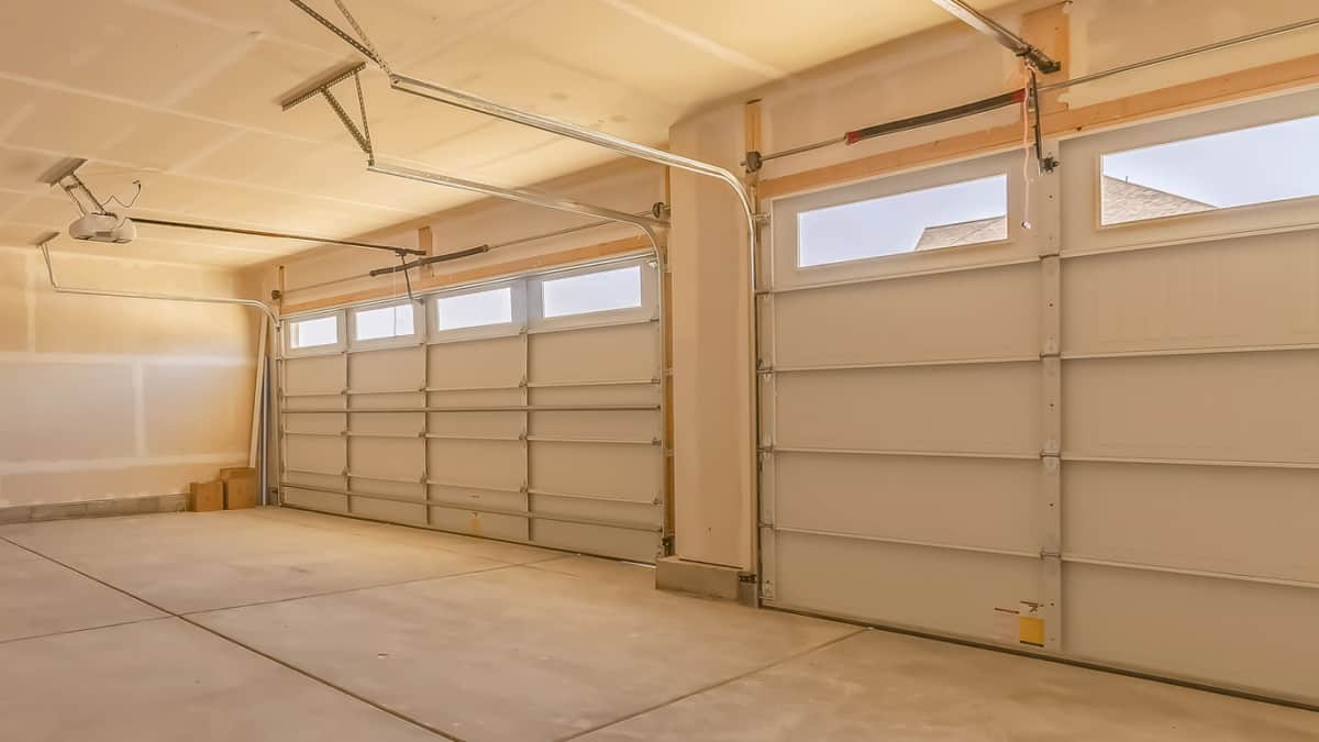 Panorama frame Interior of an empty garage with two large doors and small rectangular windows